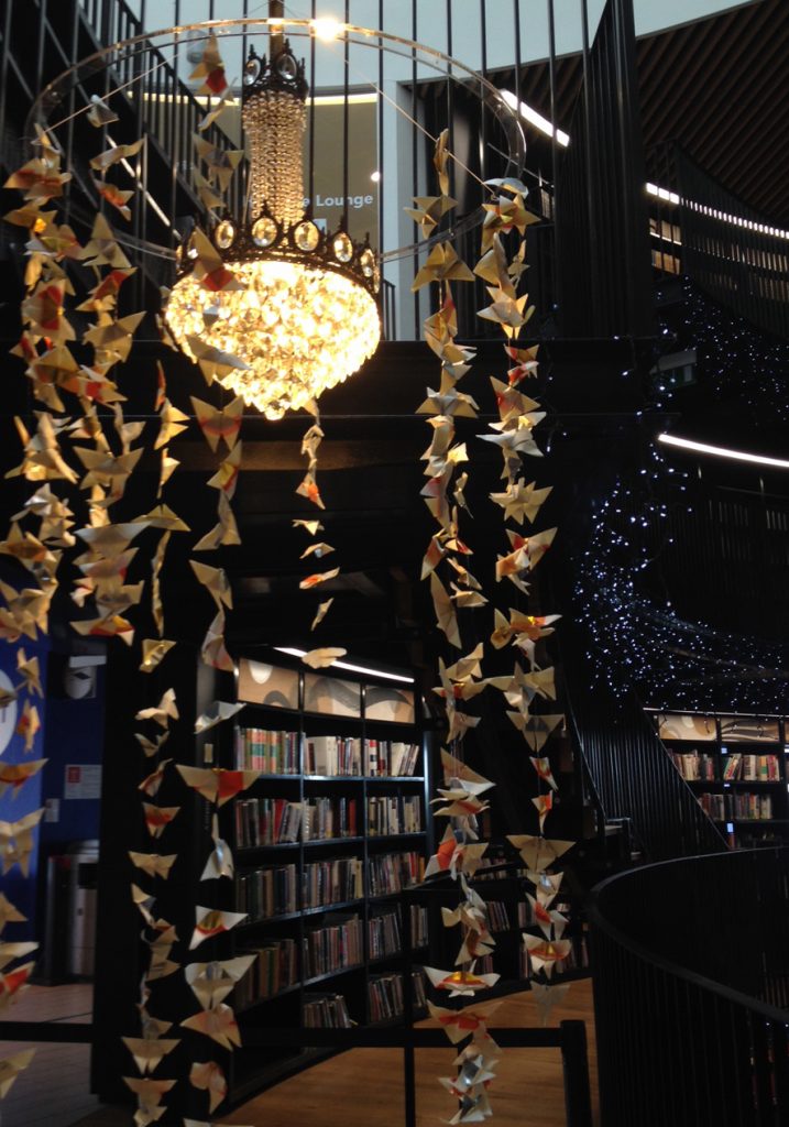 chandelier with a mobile of butterflies cascading around it