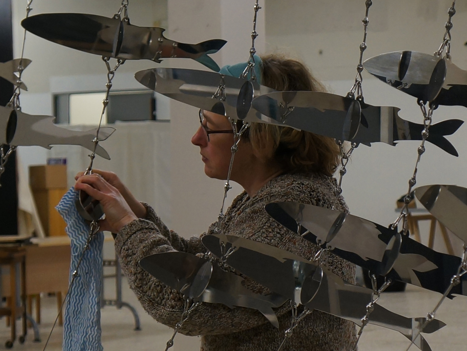 Liz Turner polishing the fish sculpture